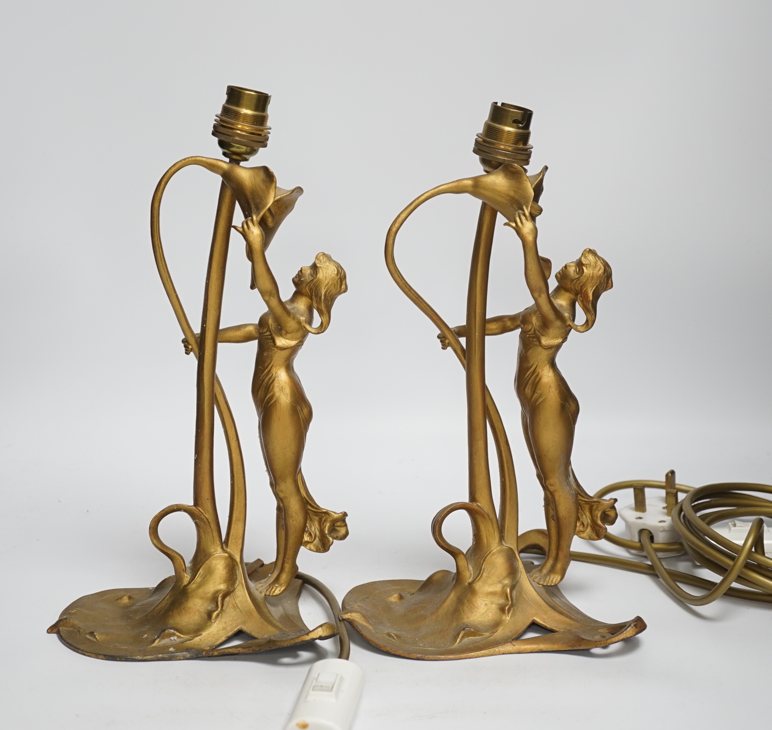 A pair of Christopher Wray, Art Nouveau style lily and figural gilt metal table lamps, 26cm high